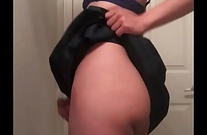 Jess shakes her ass and cock in a skirt